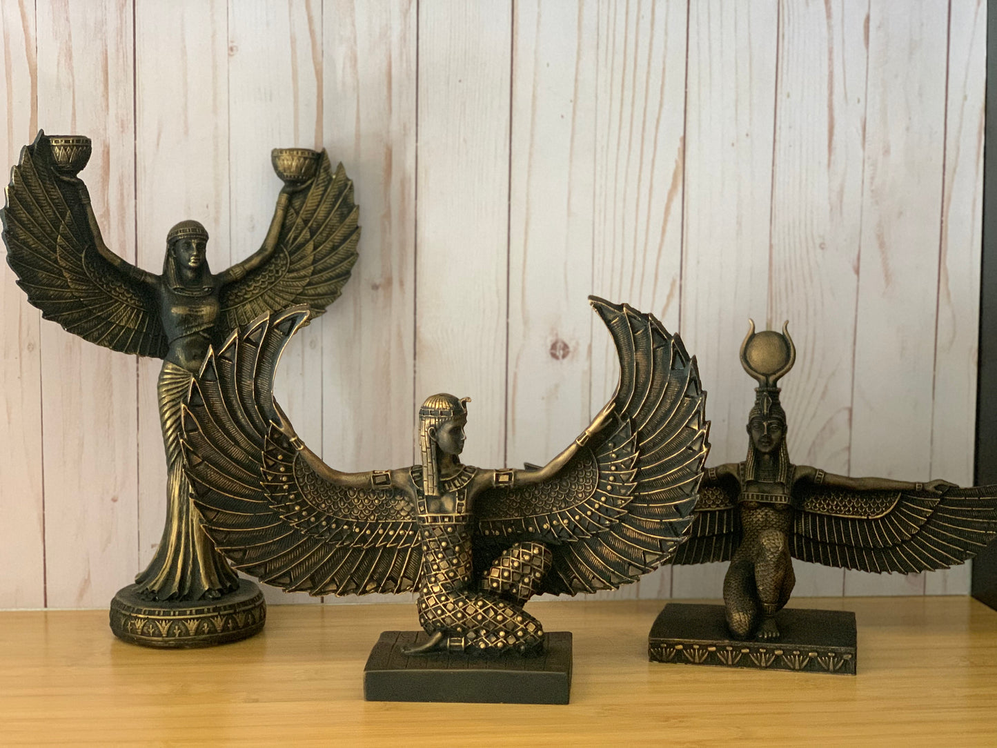 Artistically crafted Egyptian Goddess Isis statue with open wings, adorned in gold leaf, symbolizing ancient Egyptian mystique and maternal power