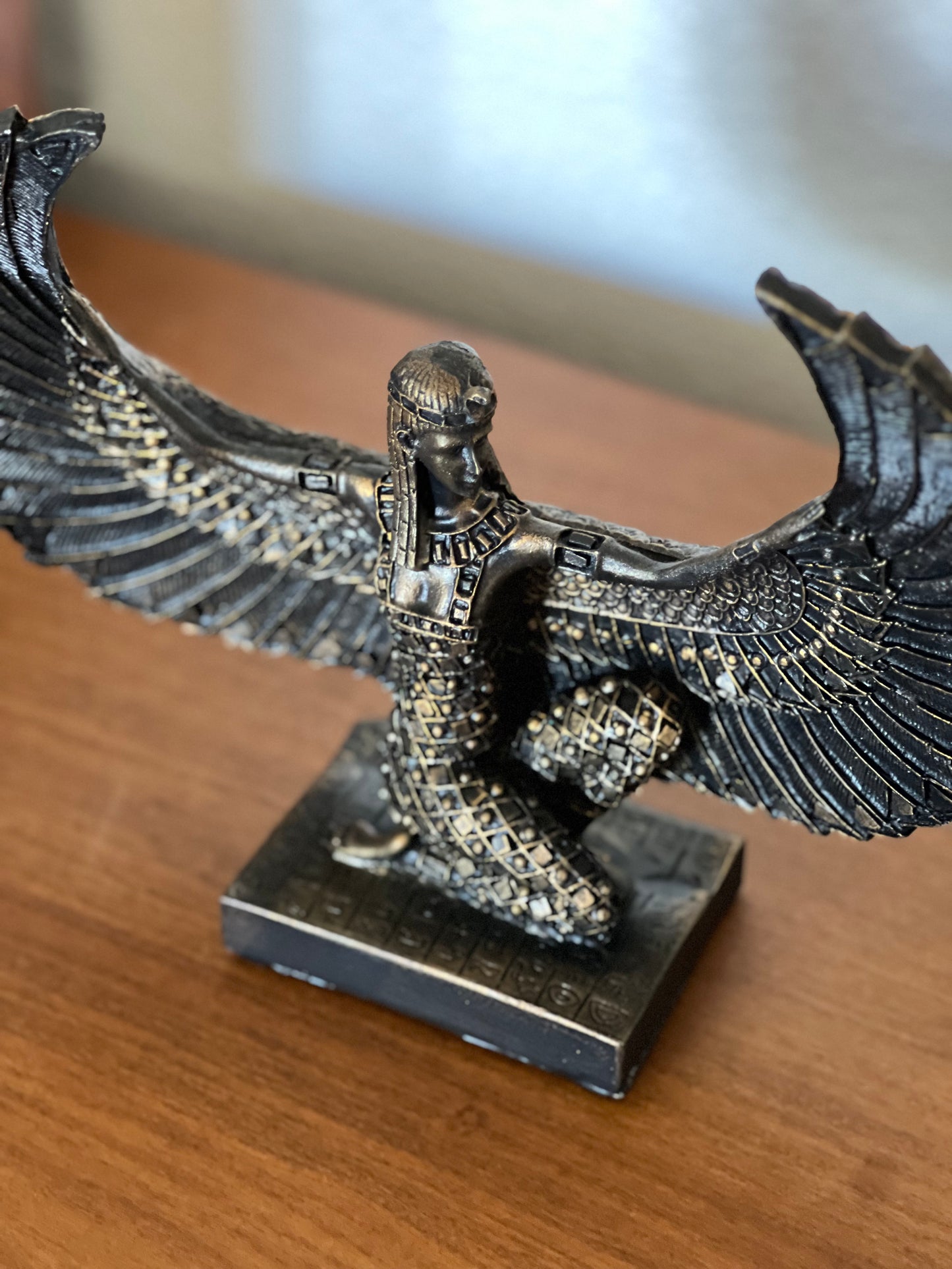 Artistically crafted Egyptian Goddess Isis statue with open wings, adorned in gold leaf, symbolizing ancient Egyptian mystique and maternal power