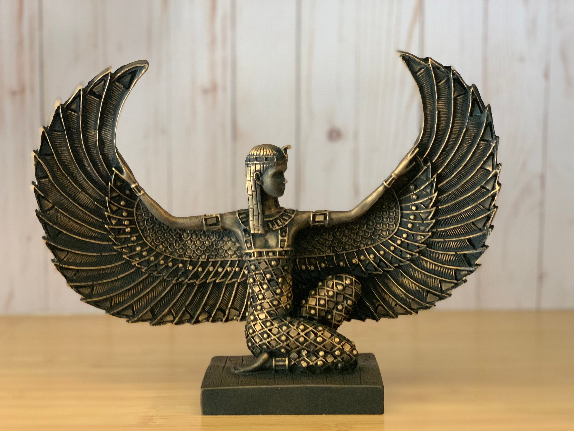 Artistically crafted Egyptian Goddess Isis statue with open wings, adorned in gold leaf, symbolizing ancient Egyptian mystique and maternal power