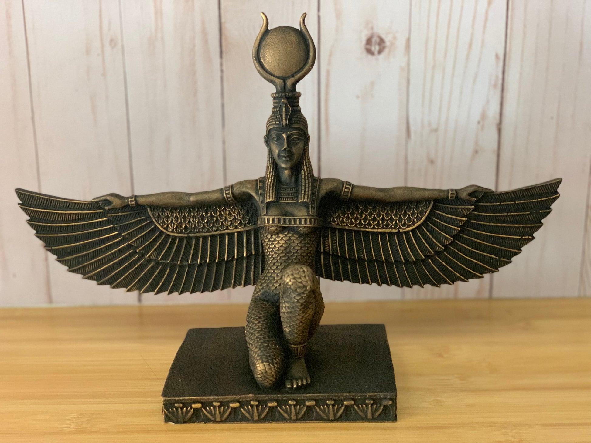 Hand-painted Egyptian Goddess Isis Statue in rich black and faux gold, ideal for home or office decor.